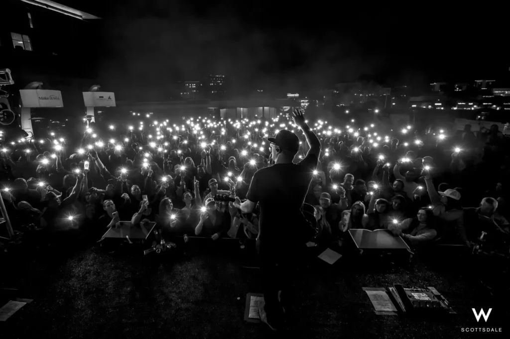 Rock the rooftop 2025 crowd phone lights from stage black and white