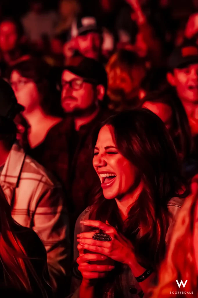 Rock the rooftop 2025 fan laughing in crowd red stage lights