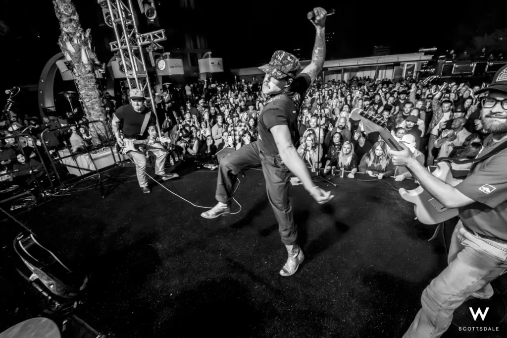 Rock the rooftop 2025 frontman jumping onstage black and white