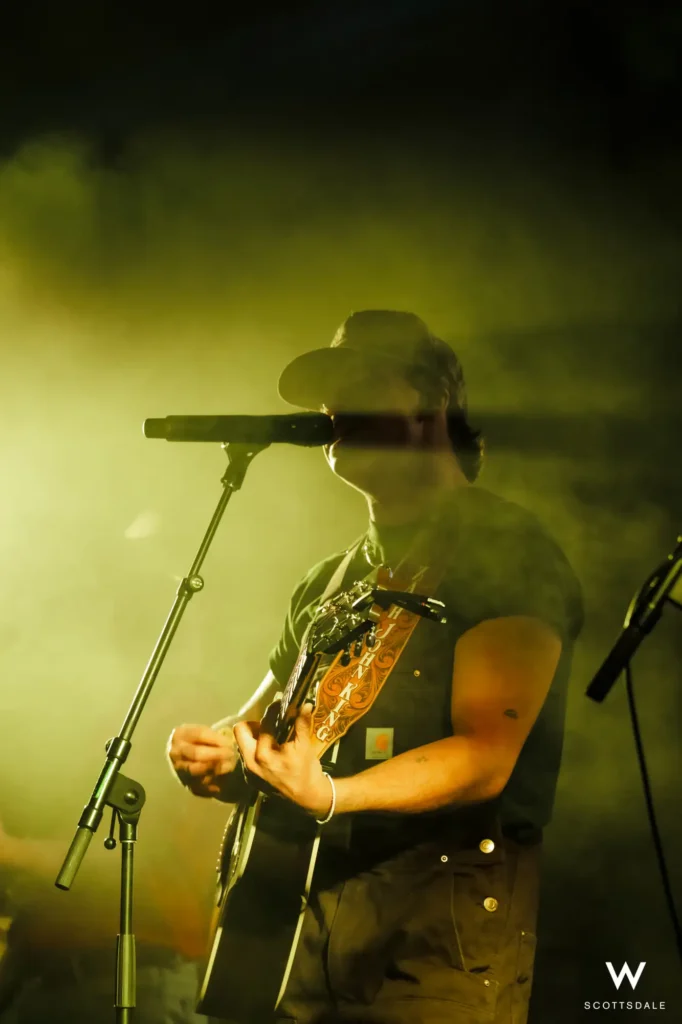 Rock the rooftop 2025 guitarist cowboy hat spotlight stage fog